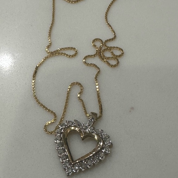 Jewelry - This is a yellow gold open heart diamond pendant necklace on a gold chain
